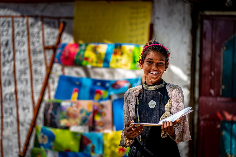 A young girl joyfully studying amidst a bustling street scene.
