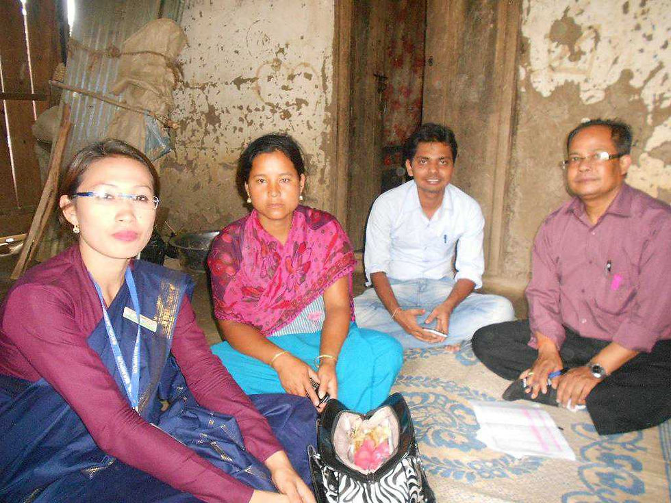 Pramod sitting with rural entrepreneurs in a hut.