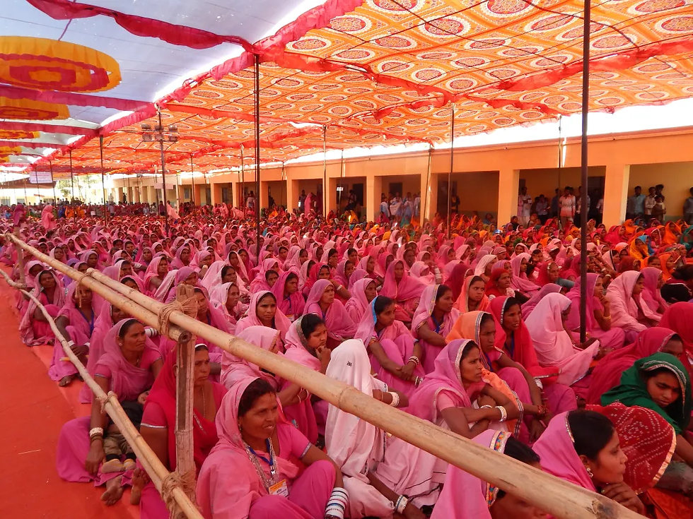 A swarm of attentive rural women in Rajasthan, eagerly engaged with the RangDe partners.