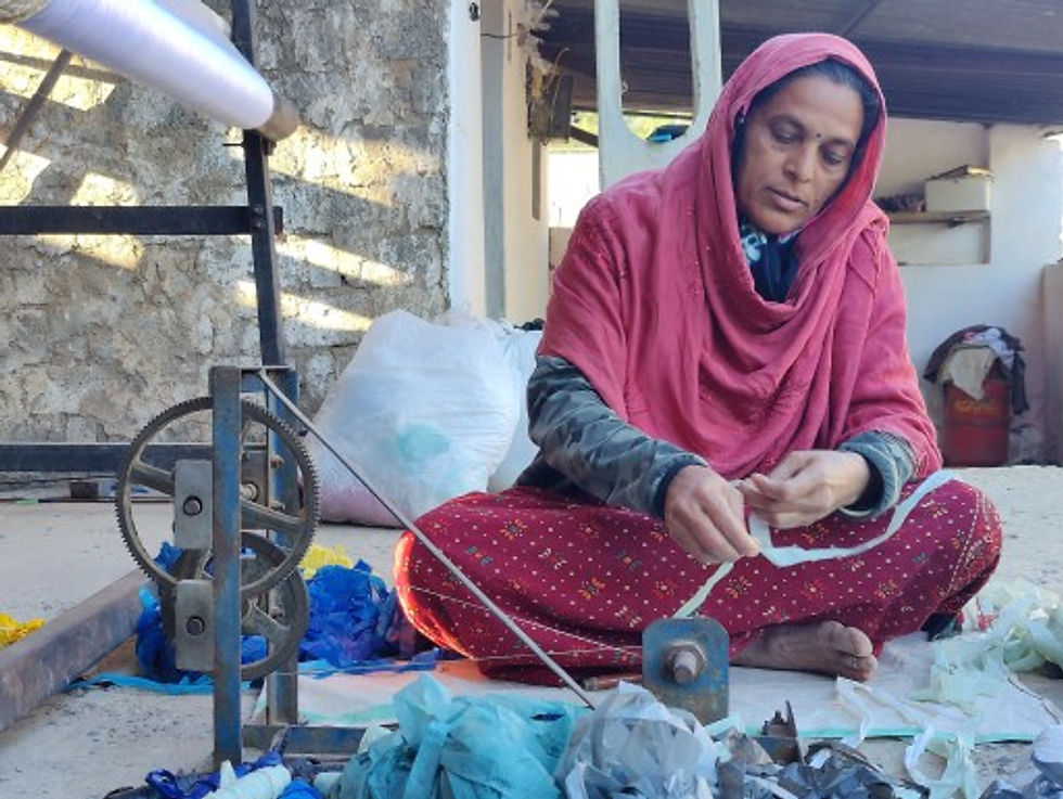 A skilled woman creating textiles on a spinning wheel with expertise and precision.
