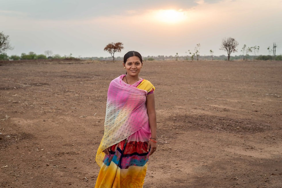 Women stands on dry terrain in Solapur.