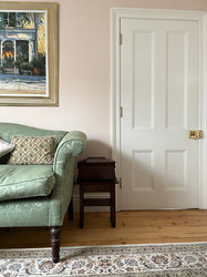 a traditional morning room fitted with bespoke made shelving units styled with an eclectic mix of antiques
the original floorboards are refurbished to complete the cottage look