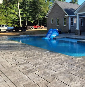 stamped concrete walkway next to pool