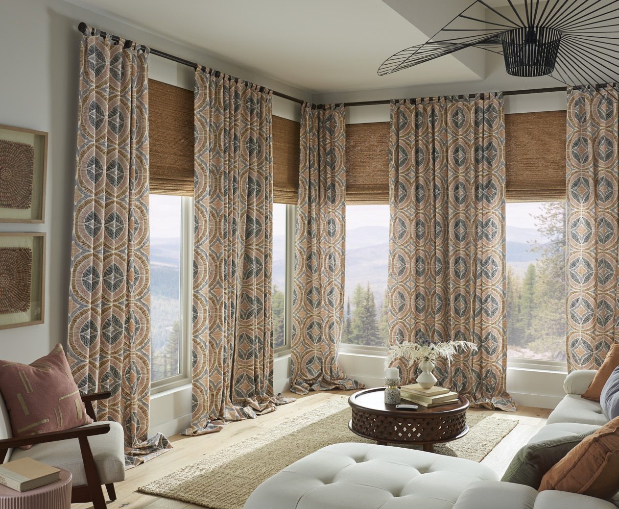 Patterned drapery over woven shades in a traditional living room