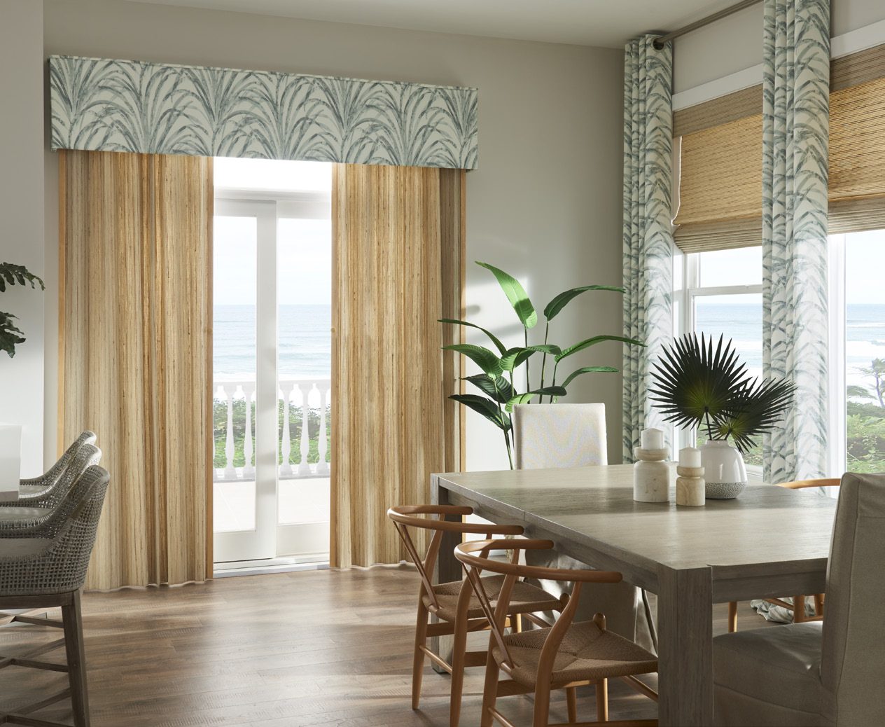 Natural woven shades under a fabric valance in a dining room