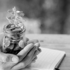 woman-hand-holding-plant-growing-from-coins-bottle_edited.jpg