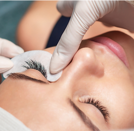 Professional Lash Artist performing eyelash extensions on a client at Eye Bliss Studio