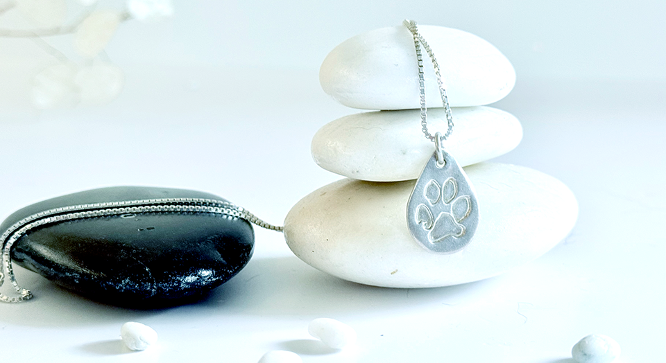 Silver necklace custom made to a pets unique paw print