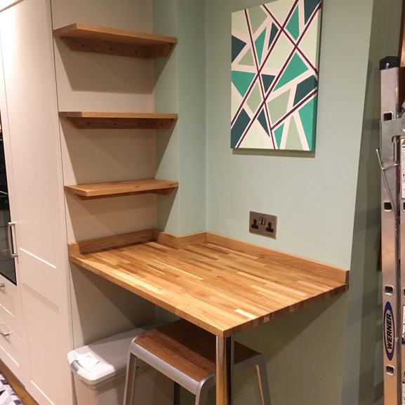 Solid oak shelves with butcher block breakfast bar.