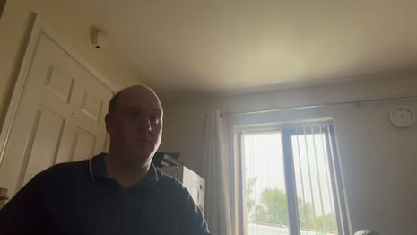 Kevin sitting in his house