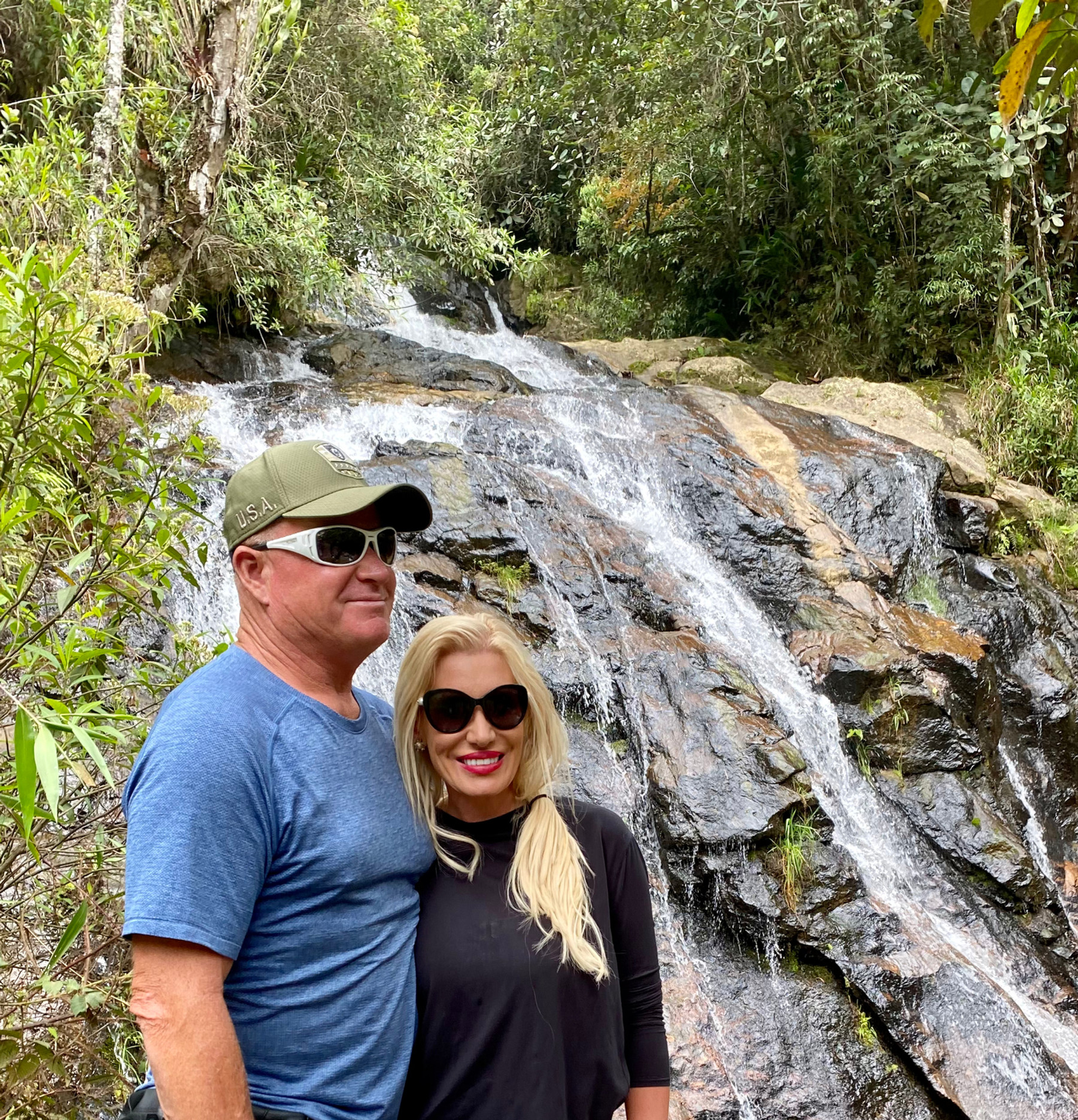 Ron Zemp and Jennifer Zemp visiting a waterfall in Guatapé, Colombia
