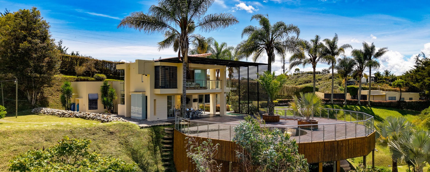 Beautiful exterior of Luxury Estate Guatapé, an exclusive luxury lakefront vacation rental in Guatapé, Colombia, surrounded by stunning natural scenery.