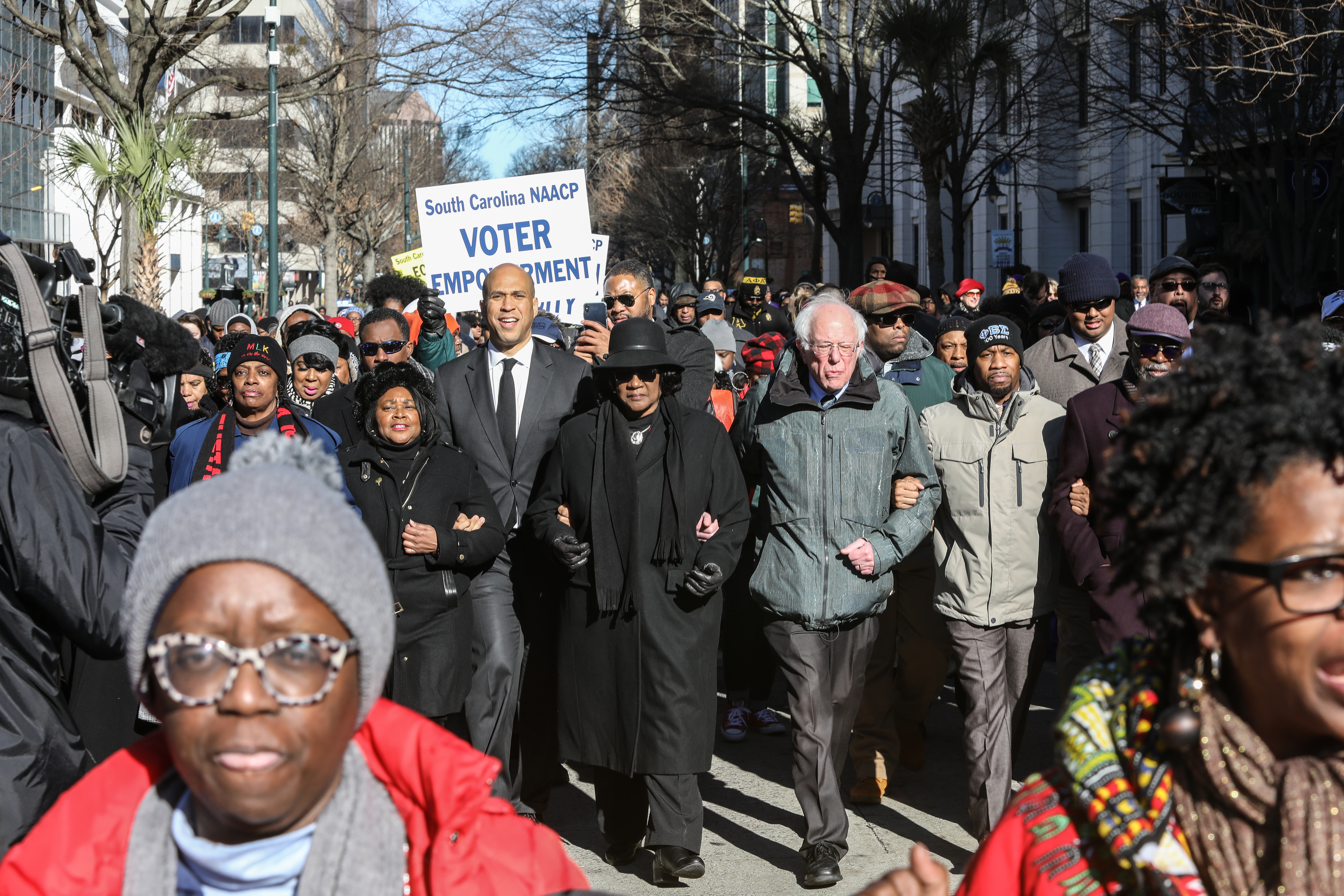 Cory Booker and Bernie Sanders march at