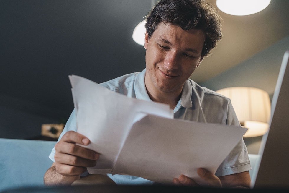 Small business owner reviewing pay stub while figuring out how to pay himself from his LLC