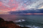 Dramatic sunset sky over the Atlantic Ocean at Cabo da Roca with waves and cliffs
