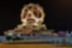 Golden geometric monument illuminated at night in Ashgabat, Turkmenistan.
