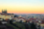 Pastel sunset over Prague Castle and city skyline viewed from Raoul Wallenberg Promenade