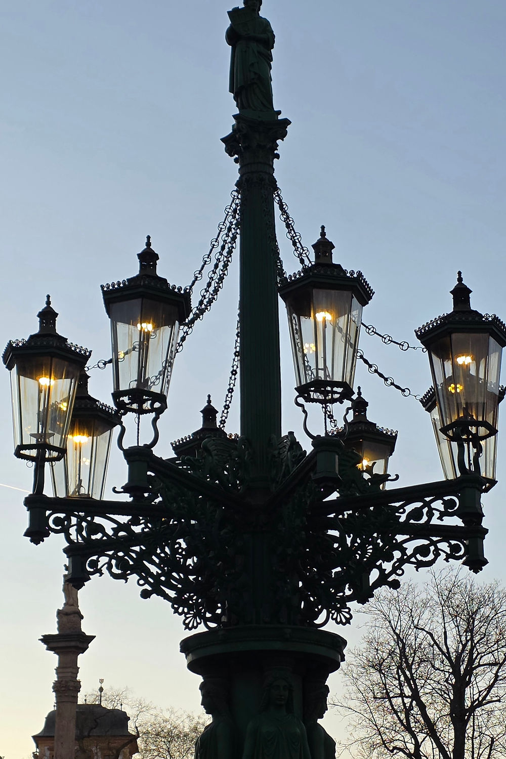 Historic gas street lamp glowing at dusk in Prague, Czech Republic