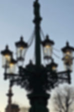 Historic gas street lamp glowing at dusk in Prague, Czech Republic
