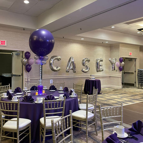 bar mitzvah centerpiece, jumbo purple balloons. name in silver jumbo mylar letters
