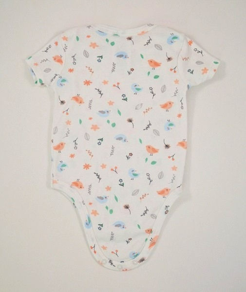 White bodysuit. Short sleeve. Birds and flower design all over.