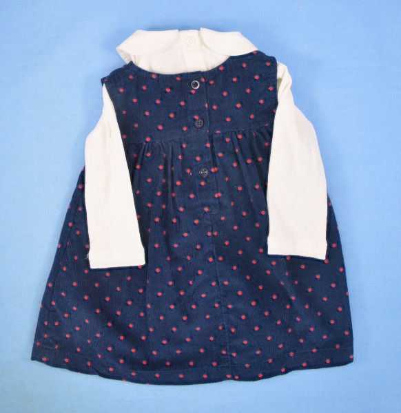 Thumbnail: Top cream.Long sleeves.Round neck.3 button fastening on back.Collar. Tights plain with navy foot and bar like shoes.