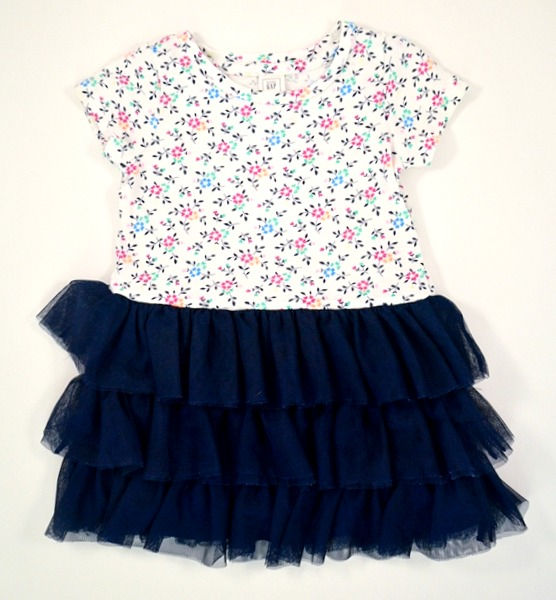 Dress in navy blue and white. Bodice and sleeves have coloured floral design.