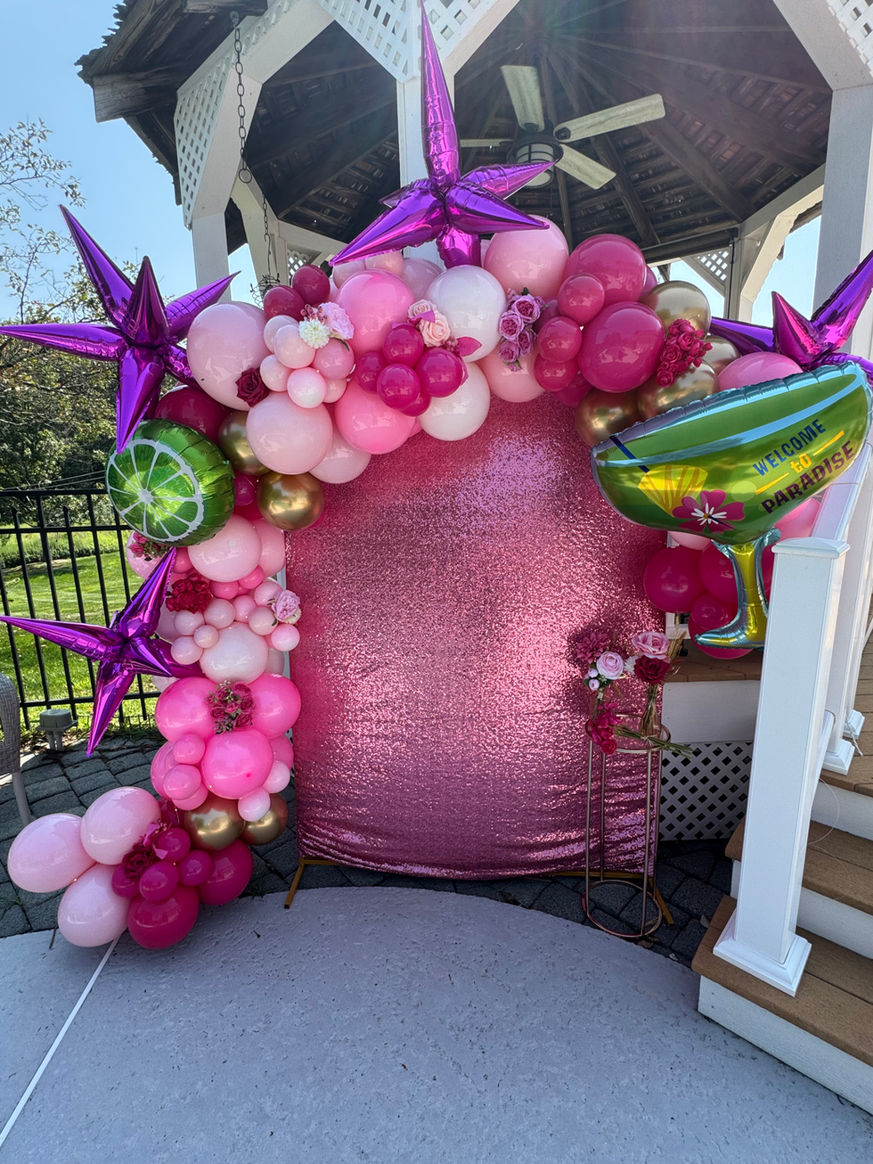 Pink sequin backdrop with diverse balloon arch and star balloons