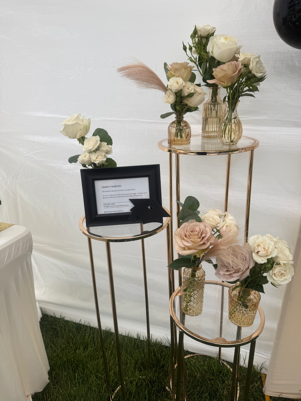 Rose gold stands, white and blush roses, framed sign, party.
