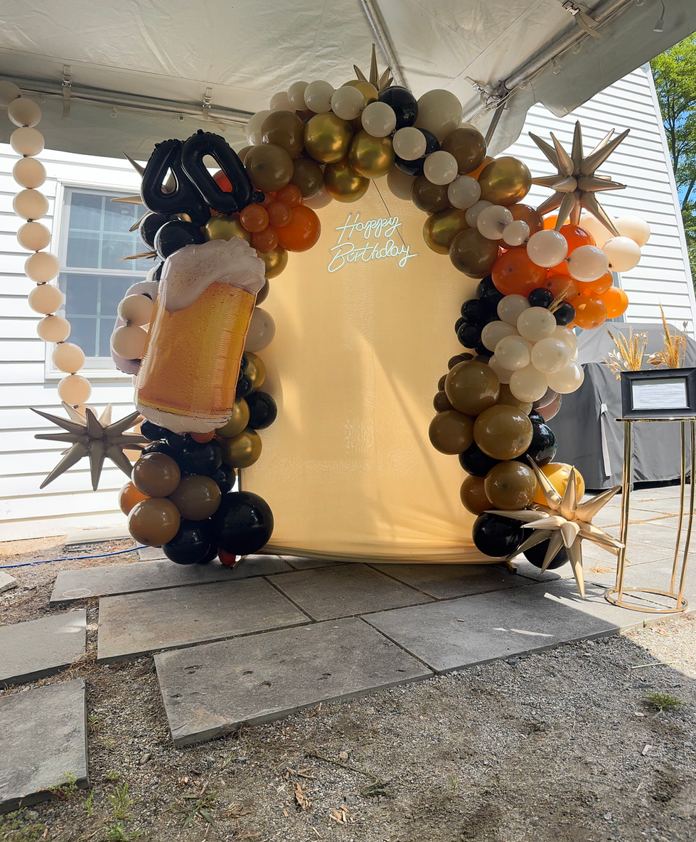 Balloon arch with beer mug and 'Happy Birthday' sign