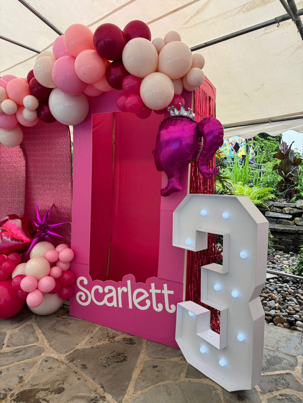 Pink photo booth with balloons, Scarlett, and number 3