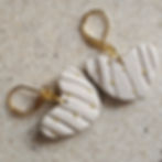 Textured heart-shaped polymer clay earrings with gold accents and hooks.