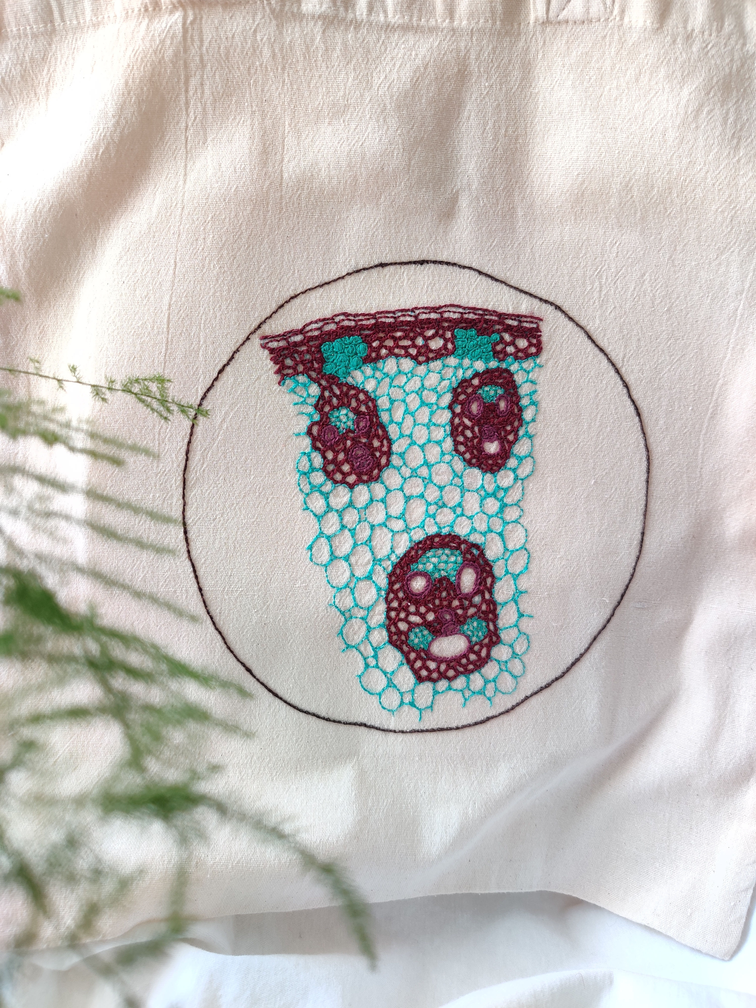 Monocot stem embroidery in turquoise and maroon thread on a cotton tote bag