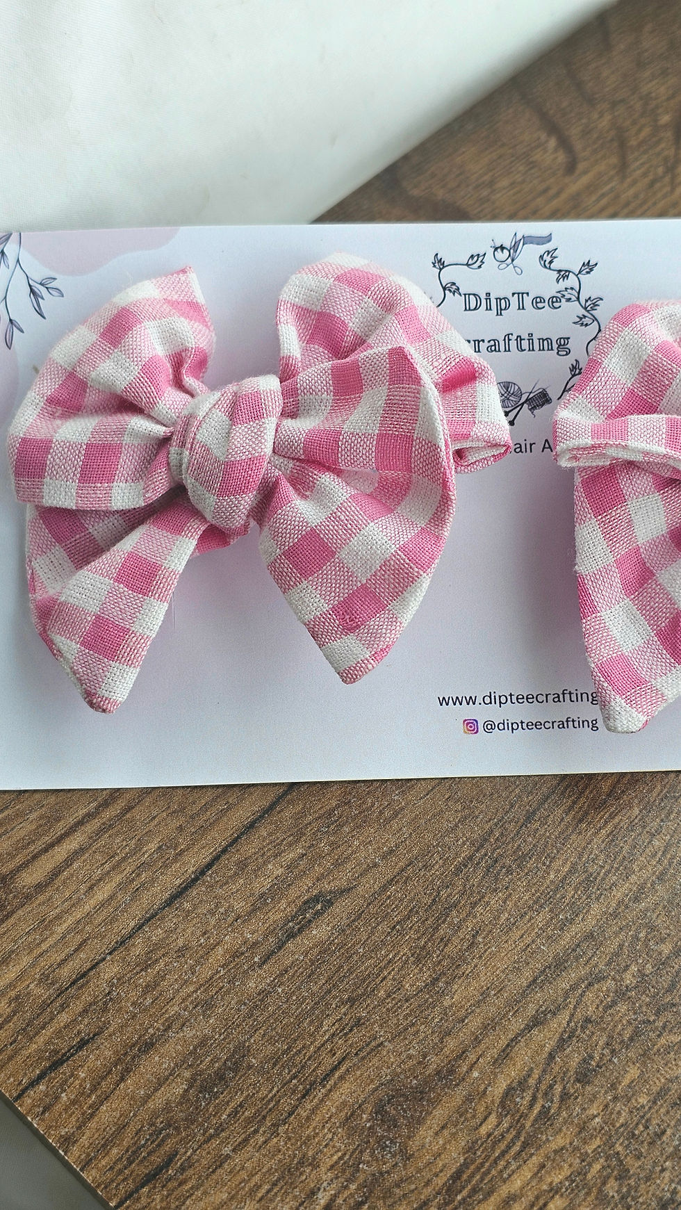 Close up pink gingham pigtail bows with branded display card