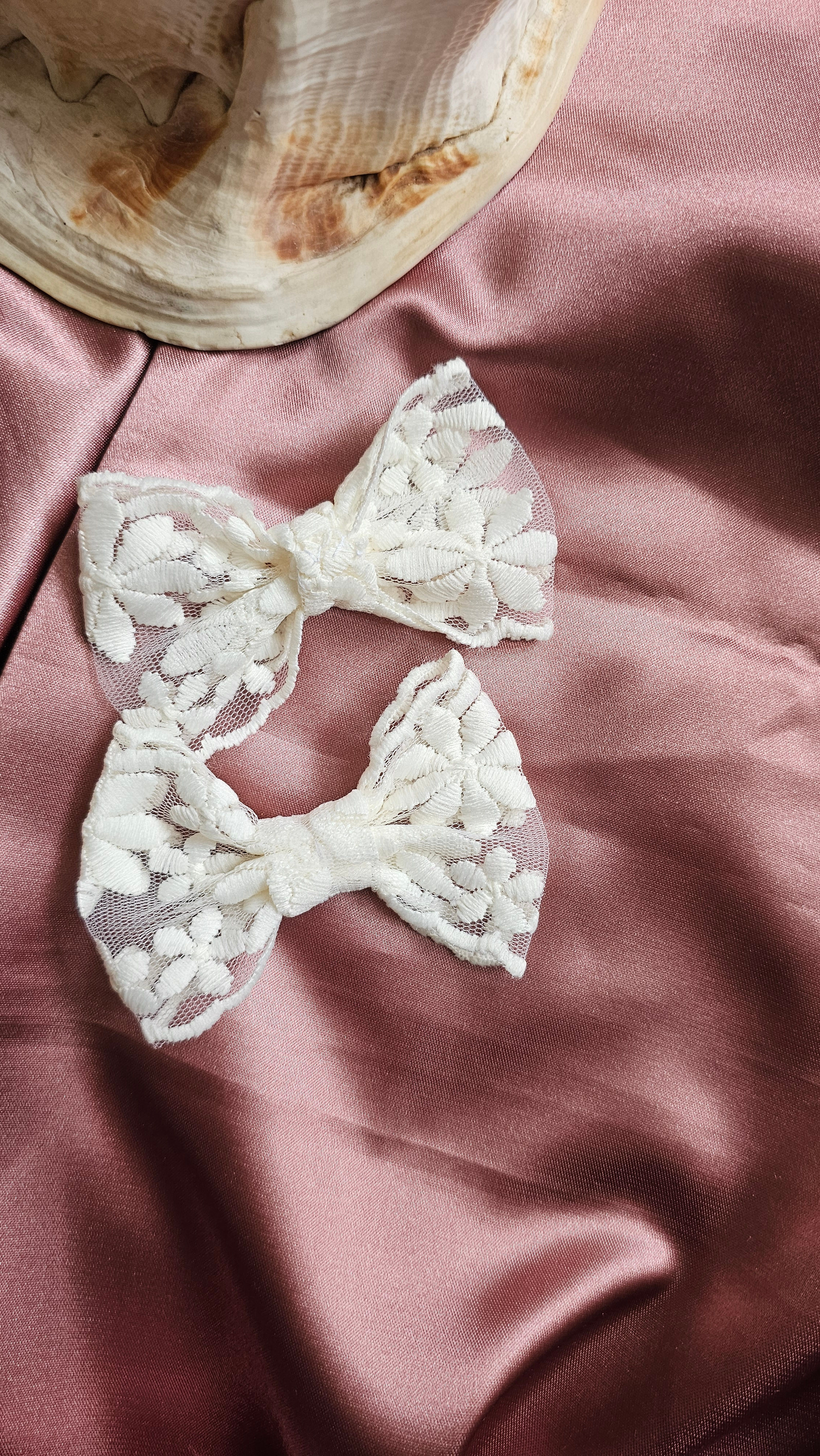 A pair of 2 white lace bows with delicate embroidered white flowers