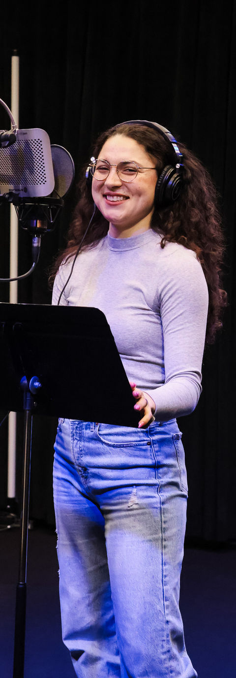 Voice actor recording a commercial voiceover demo with professional direction