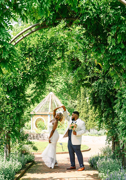 A bride and groom celebrate with newlywed portraits after a small ceremony in Inniswoods Metro Garden in Columbus Ohio