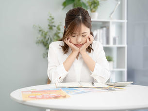 ピアノ教室の料金や資料を見ながら比較・検討している女性。