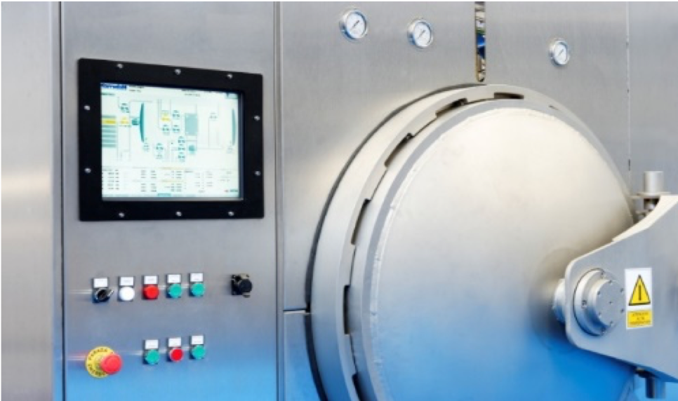 Eye-level view of an industrial autoclave control panel with digital displays