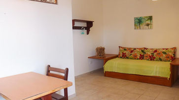 acomodacoes um quarto com cama, mesa e cadeiras. POUSADA VIVENDA ORIENTE