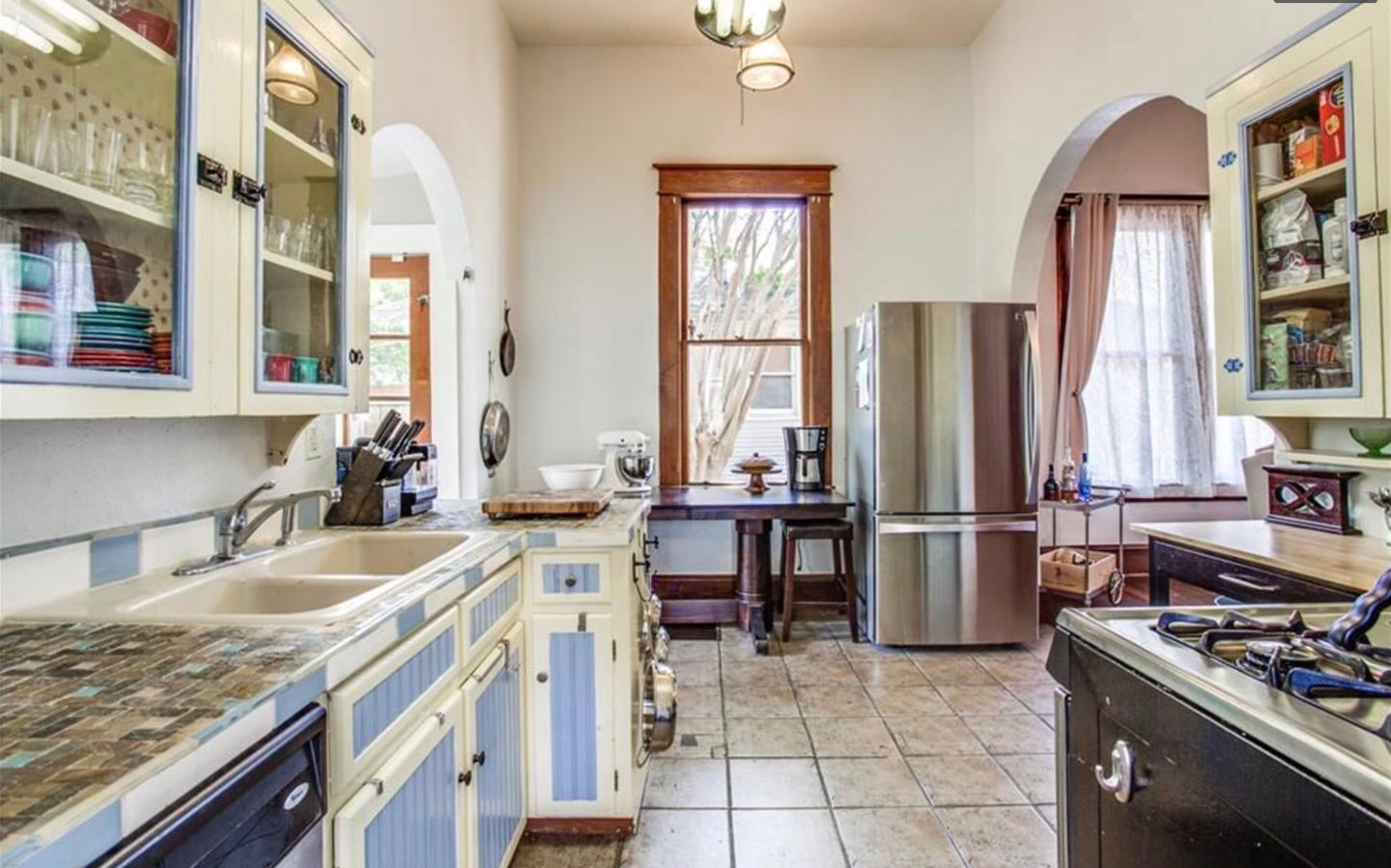 Kitchen prior to renovation showing outdated finishes and constrained workspace