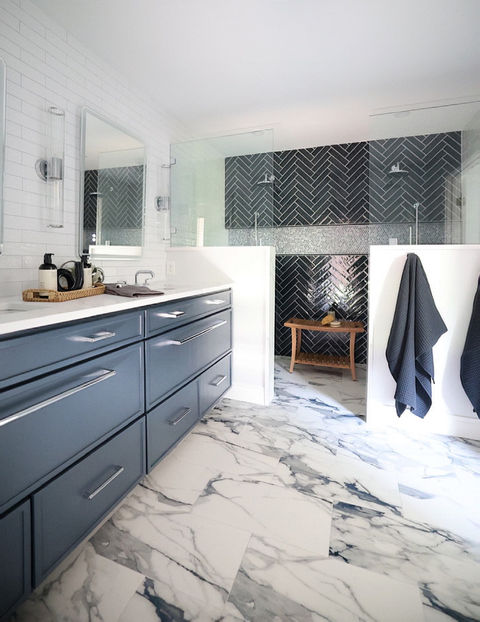 Primary bathroom with custom navy cabinetry and expanded walk-in shower by One 13 Design in Dallas home