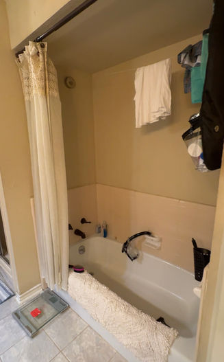 Bathroom before renovation showing original tub and layout in Dallas home prior to work by One 13 Design