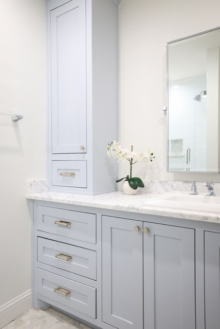 Bathroom vanity with custom cabinetry and marble countertop by One 13 Design in Dallas