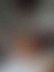 A stylish living room with a central coffee table and arranged chairs for seating.