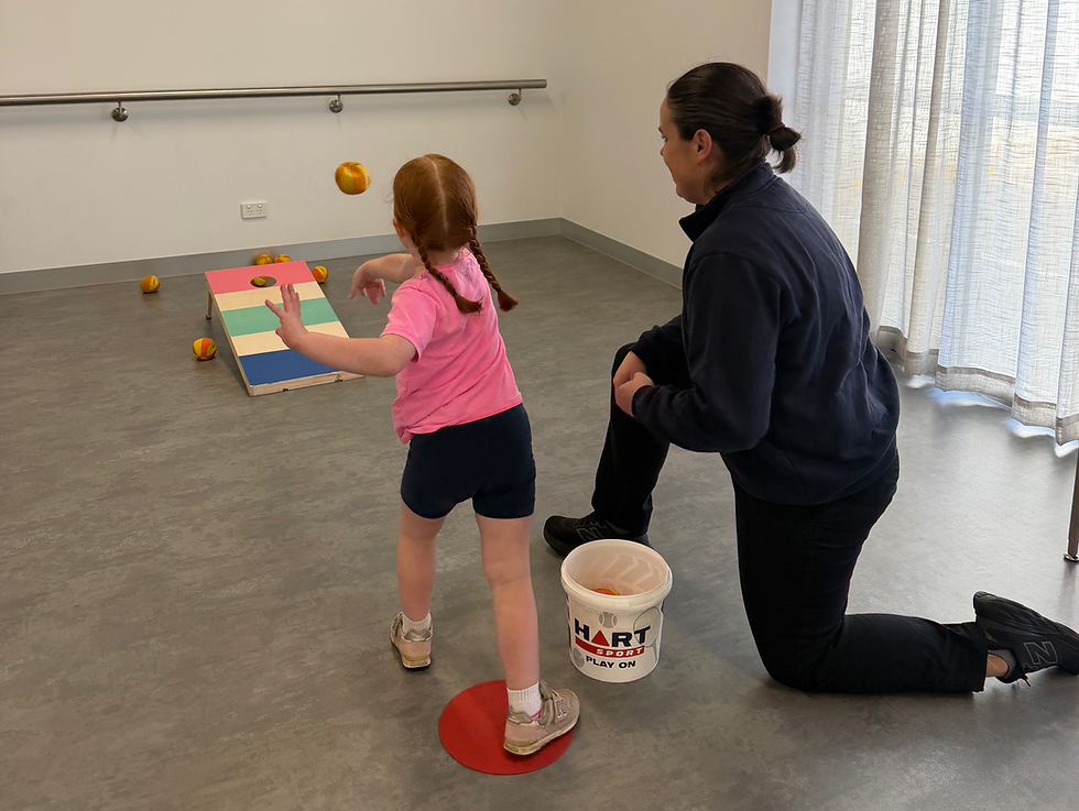 A child undergoing a gross motor skill assessment.