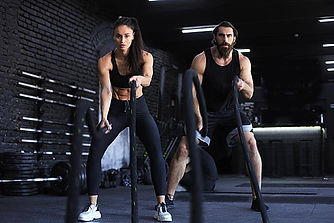 pngtree-a-fit-duo-using-a-battle-rope-during-functional-training-workout-at-the-gym-photo-