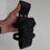 Thumbnail: Adjustable handmade black leather bottle holder, held in hand