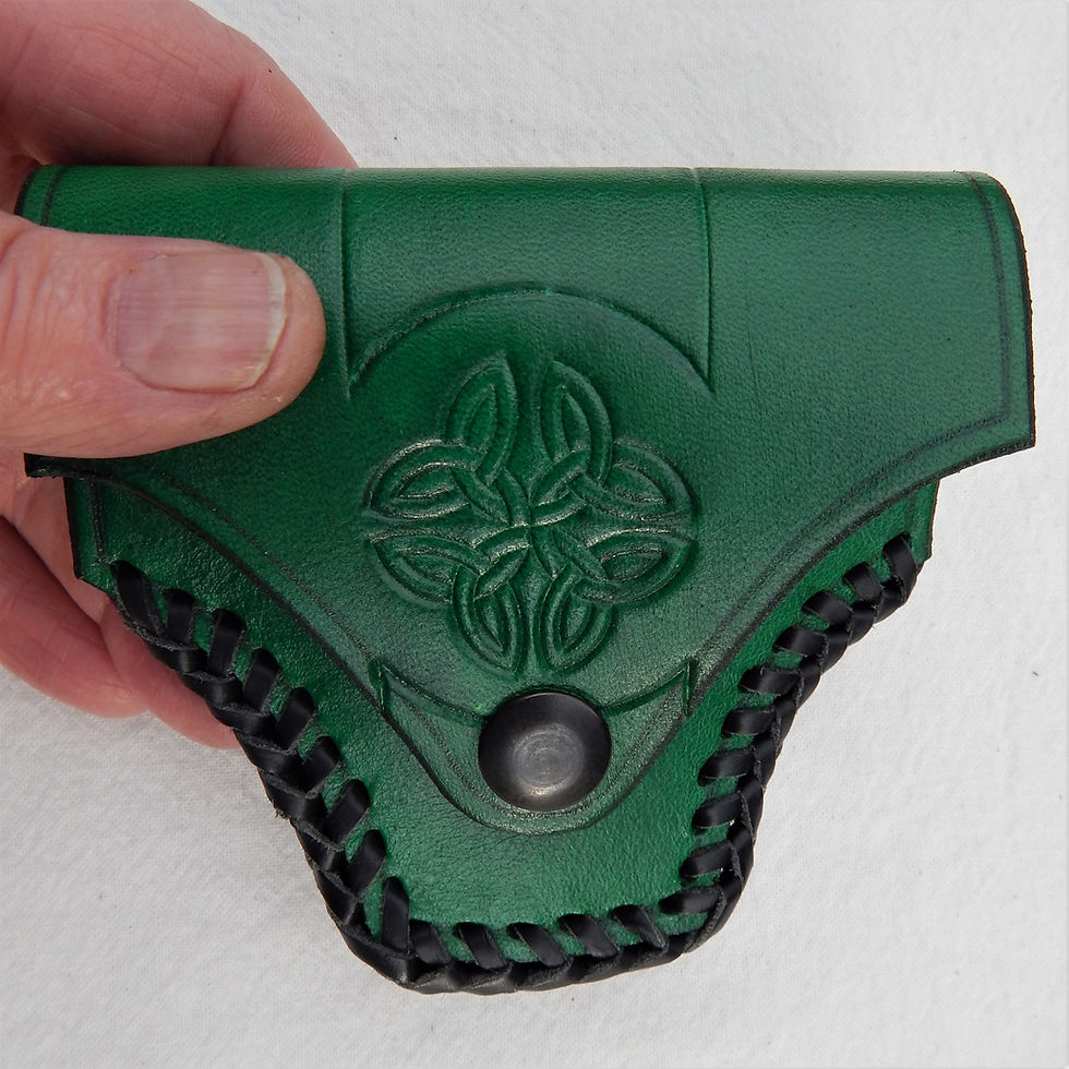 Thumbnail: Neat leather case to hold a T shaped harp tuning key.  Green one in hand showing hook and loop tape fixing strap
