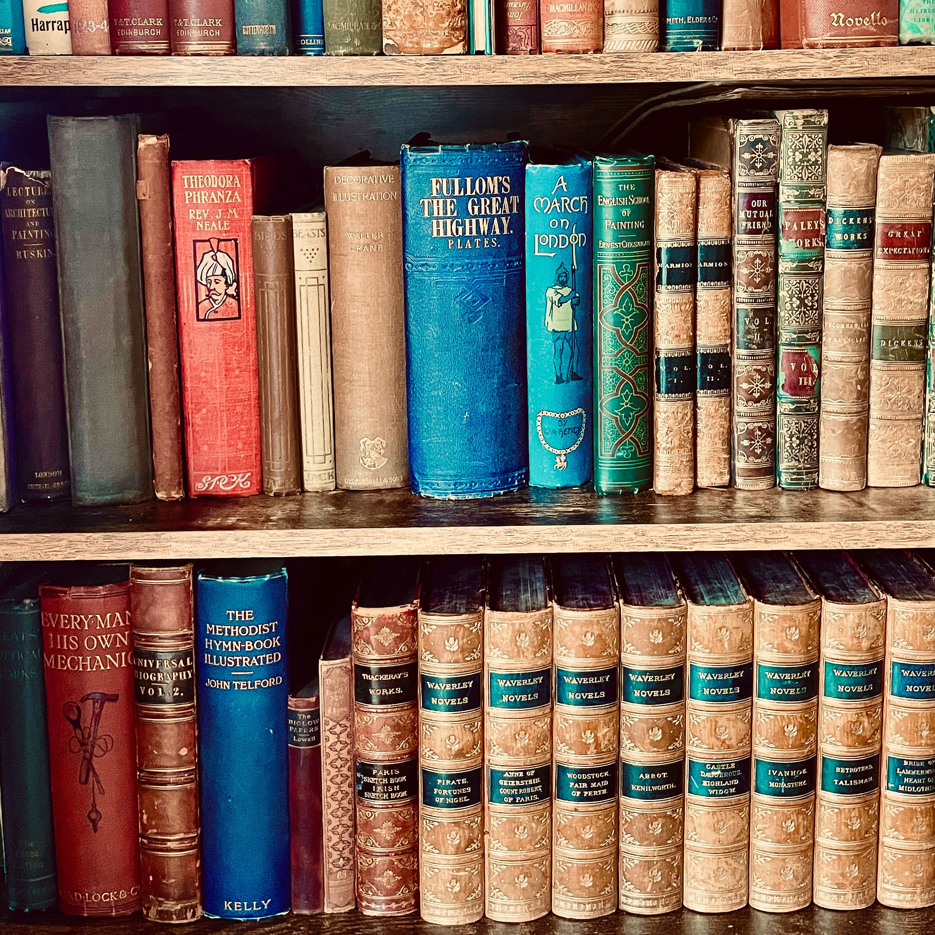 Collection of rare and antiquarian books displayed on a wooden bookcase at Literary Treasures